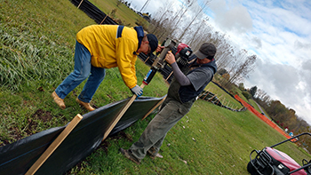 Jody Holland and Mark Fritz working on the wildflower field